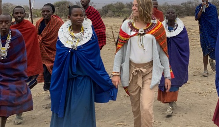 A picture of a student walking with members of the Maasai Tribe in Tanzania. 