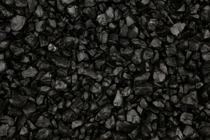 Background of shiny black grit stones. 