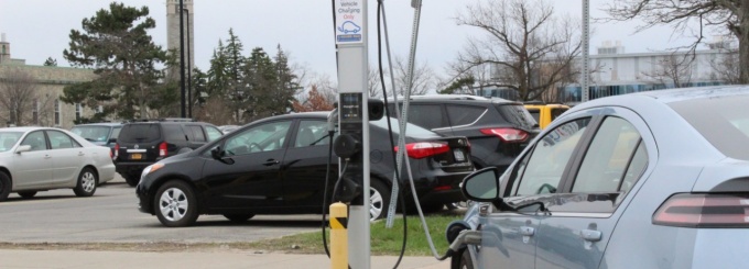 An electric car recharges at a charging station. 