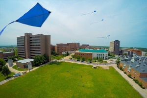 Drone view of north campus with blue kites flying in the air. 