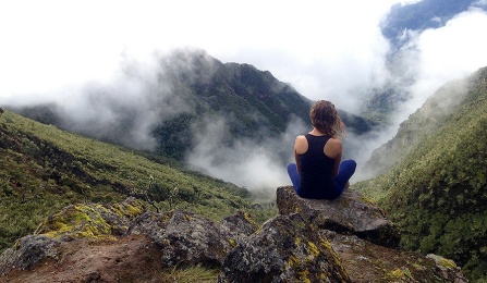 woman meditating on mountains. 