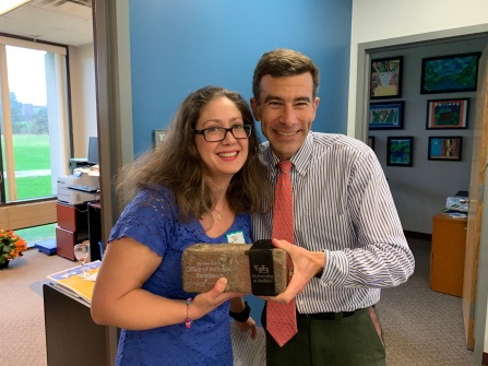 Jodi Valenti-Protas accepts the 2019 SLICE award for Sustainability Excellence by a Department or Cross Functional Team from Ryan McPherson, chief sustainability officer. 