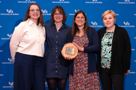 Project Coordination Office holding the 2026 SLICE award in front of a UB logo background. 