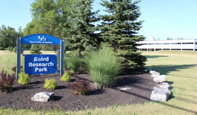 Baird Research Park sign with building in the background. 