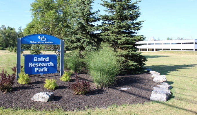 Baird Research Park sign with building in the background. 