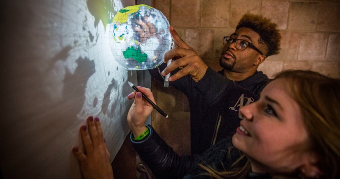 Students drawing maps in a geography class in the Ellicott complex. 