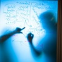 Two people strategize on a white board in the UB New York State Center of Excellence in Bioinformatics and Life Sciences. 
