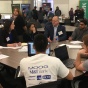 Industry representatives and students interacting at UB's Blockchain Buildathon. 