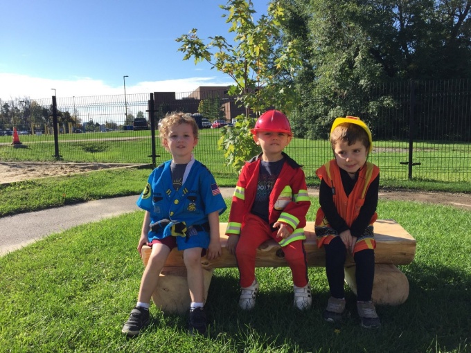3 preschool children sitting on Joel's bench. 