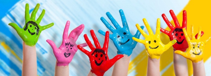 Image of painted hands with smiley faces. 