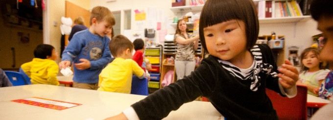 Photo - preschool child helping to clear table. 