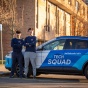 Tech Squad students with the Tech Squad car. 