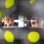 Network engineers peer into a rack of blinking servers. 