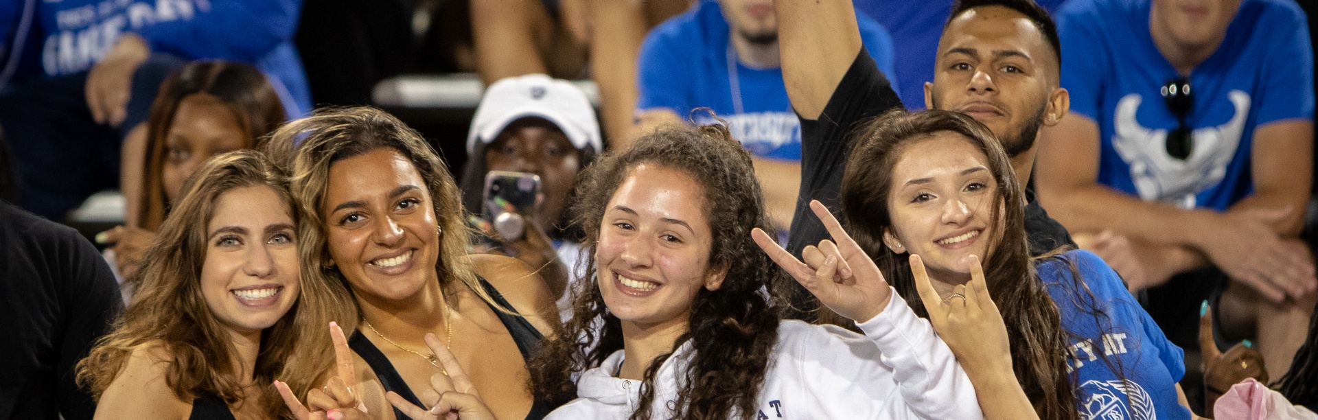Four students enjoy a UB Bulls game. 
