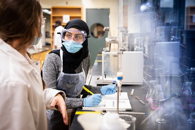 Students participate in 100 level chemistry labs in the Natural Sciences Complex in October 2020. Students demonstrate proper use of face coverings and other PPE while working in a research lab, in keeping with current guidelines. 