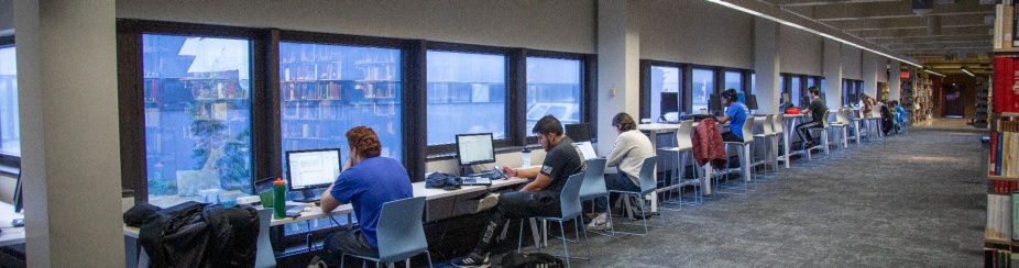 Lockwood 3rd floor library with a row of computers around the windows. 
