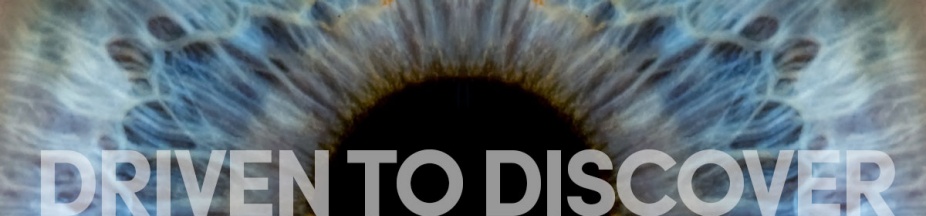 Iris of a human eye, overlaid words say "driven to discover.". 