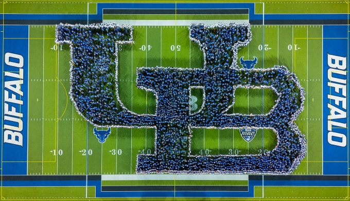 Thousands of first-year UB students gather to form the interlocking UB logo on the field at Broadview Stadium. 