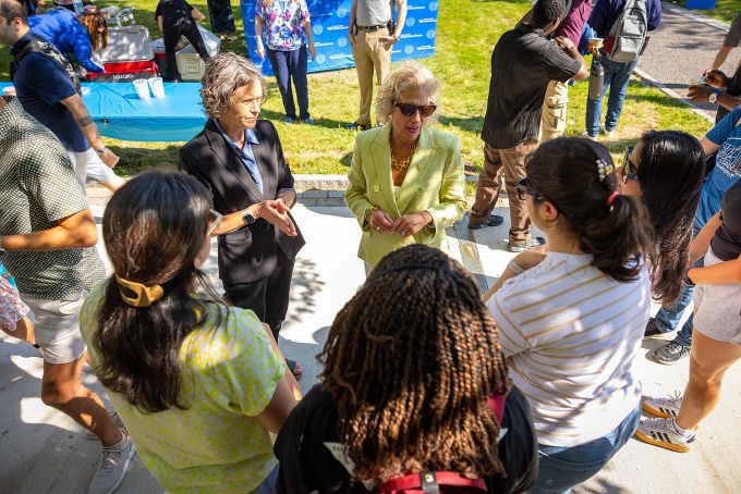 UB President Caroline Attardo Genco, PhD, speaking with students outside. 