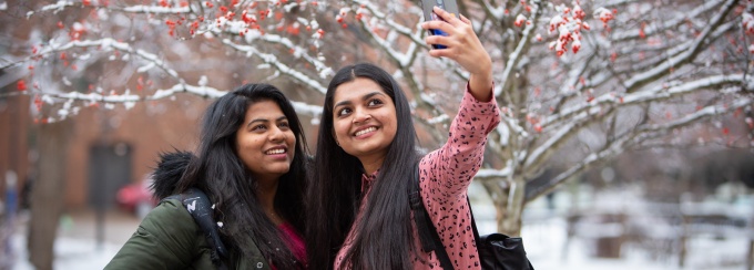 Two students taking a selfie together. 