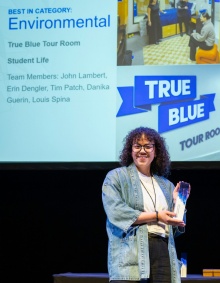 Danika accepting an award at the 2025 UB Communicators Conference. 
