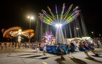Students ride the swings at the Welcome Weekend Carnival. 