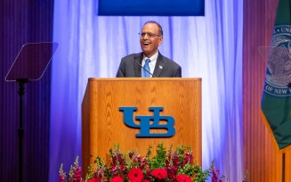 President Satish K. Tripathi speaking from behind a podium. 