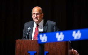 Brian Hamluk speaking behind a podium. 