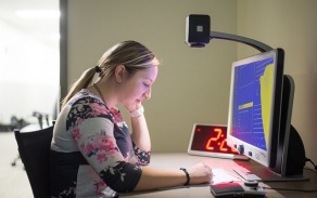 Student using assistive technology with a computer. 