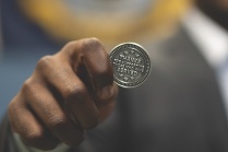 Close up of someone holding a decorative coin. 