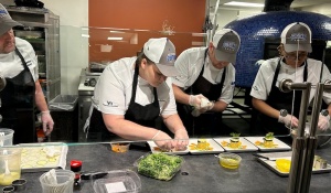 Four UB chef's preparing food for a team competition.