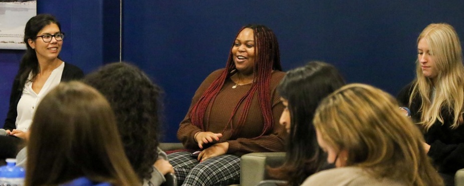 A group of women speaking to an audience.
