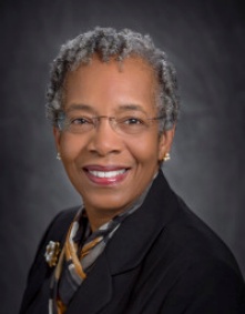Professional portrait of Dr. Saundra McGuire wearing a black blazer and a scarf. 