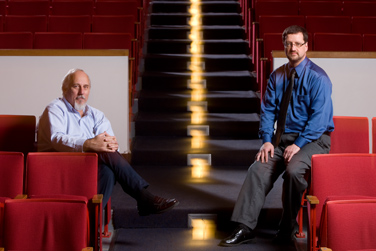 (From left) Albert Gilewicz and Phil Rehard sit in Lippes Concert Hall, where newly installed new halogena lights in the stair risers provide 100-percent dimming while still saving more than 4,000 kilowatt hours a year.
