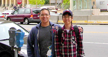 International student Jun Byung Park, right, poses in front of Buffalo City Hall with his mentor, Anthony Glaraga, an architecture major and study abroad student.